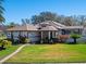 Inviting home with well-maintained lawn and beautiful tropical plants at 21850 Tartan St, Leesburg, FL 34748