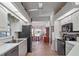 Modern kitchen with black appliances, tile floors, and a view to the breakfast nook at 21850 Tartan St, Leesburg, FL 34748