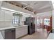 Modern kitchen with black appliances, tile floors, and a view to the breakfast nook at 21850 Tartan St, Leesburg, FL 34748