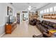 Spacious living room boasting ample shelving, natural light, and comfortable leather furniture at 21850 Tartan St, Leesburg, FL 34748