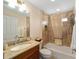 Bathroom featuring a tiled shower over tub and granite vanity at 2279 Lowell Ter, The Villages, FL 32162