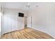 This bright bedroom features wood laminate floors and a double door closet at 2279 Lowell Ter, The Villages, FL 32162