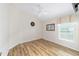 Bedroom with wood laminate flooring and large window letting in plenty of light at 2279 Lowell Ter, The Villages, FL 32162