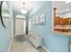 Inviting foyer featuring tile flooring, a bench and access to other rooms in the home at 2279 Lowell Ter, The Villages, FL 32162