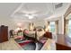 Spacious main bedroom features a tray ceiling, ceiling fan, and an ensuite bath at 2279 Lowell Ter, The Villages, FL 32162