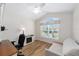 Bright home office featuring wood laminate floors and large sunny window at 2279 Lowell Ter, The Villages, FL 32162