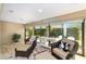 Cozy sunroom featuring comfortable wicker chairs and a view of the outdoors at 2279 Lowell Ter, The Villages, FL 32162