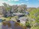 An aerial view of a home featuring a boat house on a waterfront canal at 2439 Cr 453, Lake Panasoffkee, FL 33538