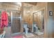 Modern bathroom with a glass-enclosed shower, a toilet, vanity with modern lighting, and tiled walls at 2439 Cr 453, Lake Panasoffkee, FL 33538