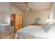 Bright bedroom features a large bed with floral patterned bedding and natural light at 2439 Cr 453, Lake Panasoffkee, FL 33538