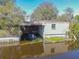 Waterfront property with a boathouse, offering convenient storage and access for boating enthusiasts at 2439 Cr 453, Lake Panasoffkee, FL 33538