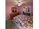 A bedroom with a bed, dresser, ceiling fan and mirrored closet doors at 25124 Twelve Oaks Rd, Leesburg, FL 34748