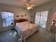 Bedroom featuring a floral bedspread, sliding glass doors, and a view into a screened-in porch at 25124 Twelve Oaks Rd, Leesburg, FL 34748