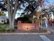 Tara View community entrance sign made of brick and well landscaped with mature trees and colorful flowers at 25124 Twelve Oaks Rd, Leesburg, FL 34748