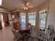 Bright dining nook with ceiling fan and a view of the front yard at 25124 Twelve Oaks Rd, Leesburg, FL 34748