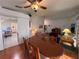 Open dining area adjacent to the living room, featuring hardwood floors and a view into the kitchen at 25124 Twelve Oaks Rd, Leesburg, FL 34748