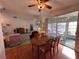 Bright dining room with hardwood floors and views into the screened-in lanai and comfortable living area at 25124 Twelve Oaks Rd, Leesburg, FL 34748