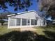 Enclosed rear porch with multiple windows at 25124 Twelve Oaks Rd, Leesburg, FL 34748