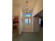 Charming entryway featuring a chandelier, glass-paneled door and sidelights, with views into the adjacent rooms at 25124 Twelve Oaks Rd, Leesburg, FL 34748