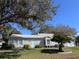 Well-maintained single-story home with aqua shutters and door at 25124 Twelve Oaks Rd, Leesburg, FL 34748