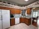 Traditional kitchen with wood cabinetry and dining nook at 25124 Twelve Oaks Rd, Leesburg, FL 34748