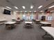 Spacious meeting room featuring tables, chairs, neutral walls, and carpet flooring at 25124 Twelve Oaks Rd, Leesburg, FL 34748