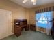 A home office featuring a built-in wooden desk adjacent to a window at 25124 Twelve Oaks Rd, Leesburg, FL 34748