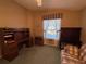 A home office featuring a wooden desk and adjacent cabinet next to an antique desk at 25124 Twelve Oaks Rd, Leesburg, FL 34748