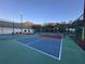 Outdoor pickleball courts with green and blue playing surfaces, surrounded by a chain-link fence at 25124 Twelve Oaks Rd, Leesburg, FL 34748