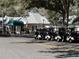 Exterior view of Plantation Oaks Restaurant with golf carts parked outside at 25124 Twelve Oaks Rd, Leesburg, FL 34748