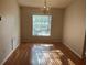 Well-lit dining room with wood floors and natural light from large window at 25212 Clifford Hl, Leesburg, FL 34748