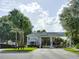 A gated community entrance, including visitor and resident lanes, surrounded by lush green trees at 25212 Clifford Hl, Leesburg, FL 34748