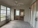 Enclosed Florida room with ceiling fan and sliding glass doors to the backyard at 25212 Clifford Hl, Leesburg, FL 34748