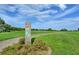 Scenic golf course view with green grass, a Par 5 sign, clear blue sky, and scattered trees at 25212 Clifford Hl, Leesburg, FL 34748