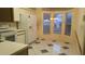 Bright eat-in kitchen with white appliances, tile flooring, and large windows at 25212 Clifford Hl, Leesburg, FL 34748