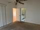 Open primary bedroom with ceiling fan and en-suite bathroom entrance at 25212 Clifford Hl, Leesburg, FL 34748