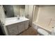 The bathroom boasts a vanity with a white countertop and ample storage plus a shower and toilet at 2541 Privada Dr, The Villages, FL 32162