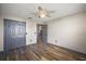 This bedroom features stylish wood flooring, a ceiling fan, and a convenient double-door closet at 2541 Privada Dr, The Villages, FL 32162