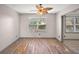 Sunlit living room features wood-look floors, a large window and neutral paint at 2541 Privada Dr, The Villages, FL 32162