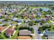 Beautiful aerial view of a residential community with lake, golf course, and well-maintained landscaping at 2667 Collington Dr, The Villages, FL 32162