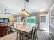 The dining area showcases modern lighting fixtures and flows seamlessly into the living room with a sliding glass door at 2667 Collington Dr, The Villages, FL 32162