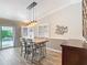 This dining area features a wood table, pendant lighting, and sliding glass doors leading to the outdoor space at 2667 Collington Dr, The Villages, FL 32162