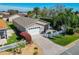 Aerial view showcasing the property's tidy landscaping, driveway, and charming exterior features at 2667 Collington Dr, The Villages, FL 32162