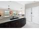 This kitchen showcases granite countertops, a sleek dishwasher, and an open layout into the living area at 2667 Collington Dr, The Villages, FL 32162