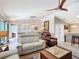 This living room is completed with contemporary seating, an accent wall, and modern light fixtures at 2667 Collington Dr, The Villages, FL 32162