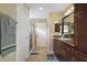 Bathroom featuring tiled floors, vanity with granite countertop, and glass shower at 2882 Adrienne Way, The Villages, FL 32163