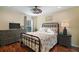 Comfortable bedroom featuring wood floors, coastal decor, and ceiling fan at 2882 Adrienne Way, The Villages, FL 32163