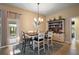 Charming dining area featuring a modern table, stylish chairs, and a unique display cabinet at 2882 Adrienne Way, The Villages, FL 32163