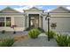 Inviting front entrance with meticulously landscaped gravel garden and elegant address display at 2882 Adrienne Way, The Villages, FL 32163