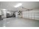 Spacious garage with epoxy floor and ample space for storage and workbench at 2882 Adrienne Way, The Villages, FL 32163